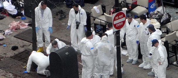 BOSTON - APRIL 16: Investigators in white jumpsuits work the crime scene on Boylston Street following yesterday's bomb attack at the Boston Marathon April 16, 2013 in Boston, Massachusetts. Security is tight in the City of Boston following yesterday's two bomb explosions near the finish line of the Boston Marathon, that killed three people and wounding hundreds more. (Photo by Darren McCollester/Getty Images)