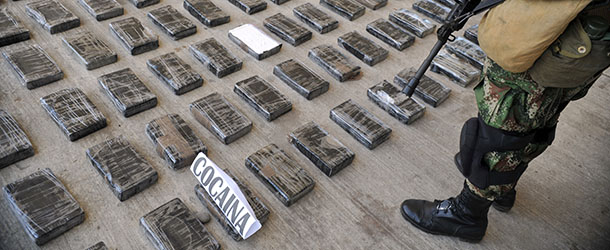 A soldier guards a shipment of 3,9 tons of cocaine seized in a large clandestine laboratory for the production of the drug, during its presentation to the press on March 16, 2013, at the military air base in Tumaco, Narino department, Colombia. Soldiers from special counternarcotics brigade found and destroyed on 13 March, in the municipality of Timbiqui, Cauca deparment, a huget laboratory to produce cocaine, considered by authorities as the largest collection center for alkaloids processing of the Revolutionary Armed Forces of Colombia (FARC) and from which drug was sent to Central and North America, officials said. AFP PHOTO/Guillermo Legaria (Photo credit should read GUILLERMO LEGARIA/AFP/Getty Images)