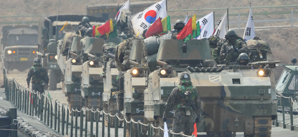 South Korean K-200 armoured vehicles move over a temporary bridge during a river-crossing military drill in Hwacheon near the border with North Korea on April 1, 2013. South Korea's new president promised a strong military response to any North Korean provocation after Pyongyang announced that the two countries were now in a state of war. AFP PHOTO / KIM JAE-HWAN (Photo credit should read KIM JAE-HWAN/AFP/Getty Images)