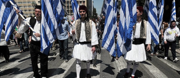 Athens and Thessaloniki municipal workers and contract workers, some wearing traditional folk uniforms, march on April 26, 2013 towards the Greek parliament in Athens to protest the latest law enshrining the latest reforms agreed with its troika of international creditors earlier this month in return for 8.8 billion euros ($11.4 billion) in bailout loans. The legislation, slated for a vote late on April 28, formalizes the dismissal of 15,000 civil servants by 2014, including 4,000 this year. This includes staff being pensioned off, fired for corruption of incompetence, or made redundant through the elimination of state entities. AFP PHOTO/ LOUISA GOULIAMAKI (Photo credit should read LOUISA GOULIAMAKI/AFP/Getty Images)