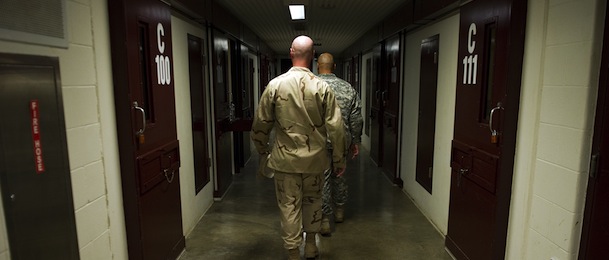 This image reviewed by the US military shows members of the military walking the hallway of Cell Block C in the "Camp Five" detention facility of the Joint Detention Group at the US Naval Station in Guantanamo Bay, Cuba, January 19, 2012. AFP PHOTO/Jim WATSON (Photo credit should read JIM WATSON/AFP/Getty Images)