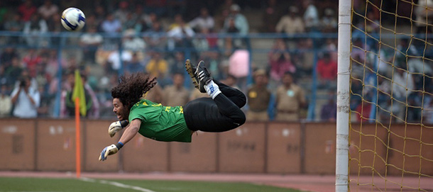 Former Colombian goolkeeper Rene Higuita kicks the ball to save a goal during an exhibition match between the Brazilian Masters and Indian All Stars in Kolkata on December 8, 2012. The Brazilian team won the match by 3-1. AFP PHOTO/ Dibyangshu SARKAR (Photo credit should read DIBYANGSHU SARKAR/AFP/Getty Images)