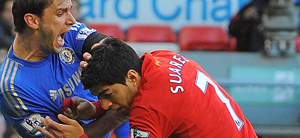 ALTERNATIVE CROP
Liverpool's Uruguayan striker Luis Suarez (R) clashes with Chelsea's Serbian defender Branislav Ivanovic (L) after appearing to bite the Chelsea player during the English Premier League football match between Liverpool and Chelsea at the Anfield stadium in Liverpool, northwest England, on April 21, 2013. Liverpool striker Luis Suarez on April 21 apologised for biting Chelsea defender Branislav Ivanovic during the sides' 2-2 Premier League draw at Anfield. The incident occurred mid-way through the second half, with Liverpool trailing 2-1 following a tussle in the penalty area. AFP PHOTO / ANDREW YATES 

RESTRICTED TO EDITORIAL USE. No use with unauthorized audio, video, data, fixture lists, club/league logos or ?live? services. Online in-match use limited to 45 images, no video emulation. No use in betting, games or single club/league/player publications. (Photo credit should read ANDREW YATES/AFP/Getty Images)