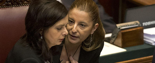 Five Stars movement lawmaker Roberta Lombardo, right, talks with Lower Chamber President Laura Boldrini during the fifth round of voting to elect a new Italian head of state, at the Lower Chamber, in Rome Saturday, April 20, 2013. On Friday Italy's polarized Parliament failed in a second day of balloting Friday to elect a president, as the high-profile candidacy of ex-Premier Romano Prodi fell far short of the votes needed. The rebuff deepened the political paralysis gripping the eurozone's third-largest economy. (AP Photo/Alessandra Tarantino)