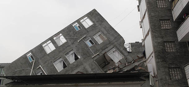 This picture taken on April 21, 2013 shows a damaged building two days after an earthquake hit, in Ya'an City, southwest China's Sichuan province. Thousands of rescue workers combed through flattened villages in southwest China in a race to find survivors from a powerful quake as the toll of dead and missing rose past 200. CHINA OUT AFP PHOTO (Photo credit should read STR/AFP/Getty Images)