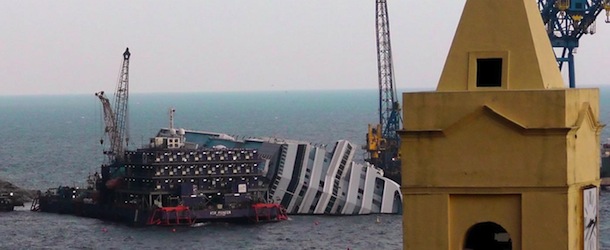 FILE - This Jan. 11, 2013 file photo shows the cruise ship Costa Concordia leaning on its side, near the shore of the Tuscan island of Giglio, Italy. Thirty-two people died when the ship ran aground on Jan. 13, 2012. Cruise watchers looking back at the industry's past year say the Concordia disaster affected everything from prices to safety drills to first-time cruisers, but bookings appear to be picking up as the 2013 cruise booking season gets under way. The first three months of each year are known as &#x201c;wave season,&#x201d;a period when many cruisers book trips as they plan ahead for summer vacations. (AP Photo/Paolo Santalucia, file)