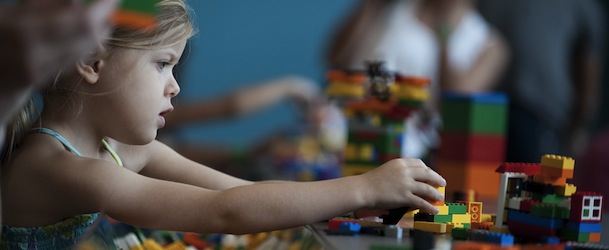 A child plays with Lego building blocks while visiting the National Building Museum's exhibit "Lego Architecture: Towering Ambition" in Washington on August 10, 2010. AFP PHOTO/Jim WATSON (Photo credit should read JIM WATSON/AFP/Getty Images)