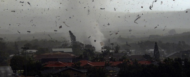 Debris flies through the air as a freak tornado tears through the coastal town of Lennox Head on June 3, 2010. The storm levelled 12 homes and damaged another 30, with twisting winds carving out a 300 metre-wide path of destruction, injuring six people and leaving thousands without power. AFP PHOTO / Ross TUCKERMAN (Photo credit should read ROSS TUCKERMAN/AFP/Getty Images)