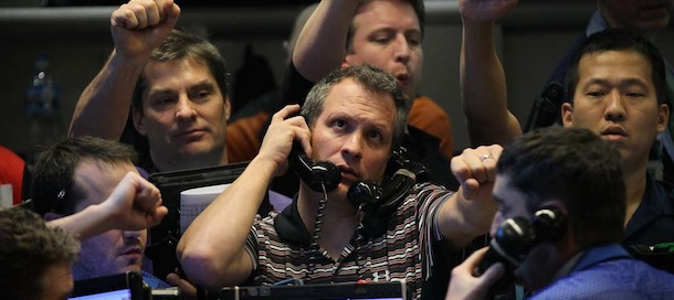 CHICAGO, IL - JANUARY 25: Traders signal offers in the Standard &amp; Poor's 500 stock index options pit at the Chicago Board Options Exchange (CBOE) following the Federal Open Market Committee meeting on January 25, 2012 in Chicago, Illinois. Following the meeting the Fed, which left interest rates unchanged, said it does not plan any rate changes until late 2014. (Photo by Scott Olson/Getty Images)