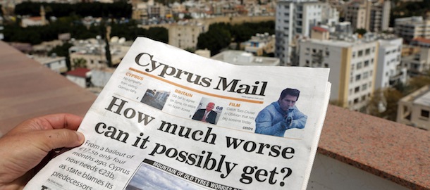 A picture taken on April 12, 2013 shows a man reading a copy of the Cyprus Mail newspaper in the capital Nicosia. Cypriot President Nicos Anastasiades said he will appeal to EU chiefs for extra assistance for the island as it faces ever more crippling terms for a eurozone debt bailout. AFP PHOTO/PATRICK BAZ (Photo credit should read PATRICK BAZ/AFP/Getty Images)