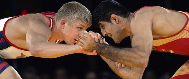 Kyle Dake (L) of the US wrestles Hassan Tahmasebi of Iran in the 74 kgclass during "Rumble on the Rails," a wrestling exhibition, at Grand Central Station in New York on May 15, 2013 . AFP PHOTO / TIMOTHY CLARY (Photo credit should read TIMOTHY CLARY/AFP/Getty Images)