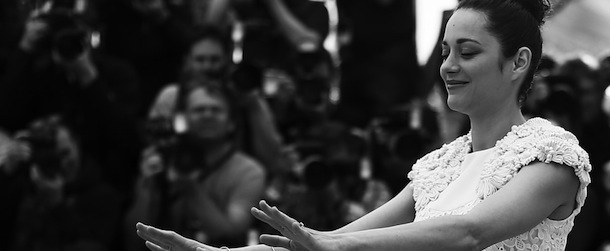 BLACK AND WHITE VERSION
French actress Marion Cotillard gestures on May 24, 2013 while posing during a photocall for the film "The Immigrant" presented in Competition at the 66th edition of the Cannes Film Festival in Cannes. Cannes, one of the world's top film festivals, opened on May 15 and will climax on May 26 with awards selected by a jury headed this year by Hollywood legend Steven Spielberg. AFP PHOTO / VALERY HACHE (Photo credit should read VALERY HACHE/AFP/Getty Images)