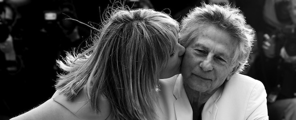 BLACK AND WHITE VERSION
French actress Emmanuelle Seigner (L) kisses on May 25, 2013 her husband, director Roman Polanski during a photocall for the film "Venus in Fur" presented in Competition at the 66th edition of the Cannes Film Festival in Cannes. Cannes, one of the world's top film festivals, opened on May 15 and will climax on May 26 with awards selected by a jury headed this year by Hollywood legend Steven Spielberg. AFP PHOTO / VALERY HACHE (Photo credit should read VALERY HACHE/AFP/Getty Images)