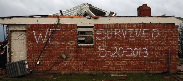 A survivor's message is left on the side of a home on Heather Lane in Moore, Okla., on Tuesday, May 21, 2013. A massive tornado swept through the south Oklahoma City suburb Monday afternoon. (AP Photo/The Dallas Morning News, Brad Loper)