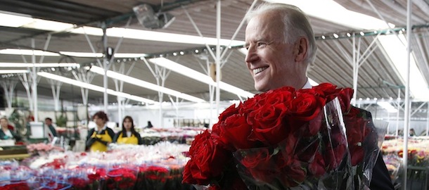 Vice President Joe Biden holds bouquets of roses presented to him by a worker during a visit to the Serrezuela flowers plantation in Madrid, in the outskirts of Bogota, Colombia, Monday, May 27, 2013. (AP Photo/Fernando Vergara)