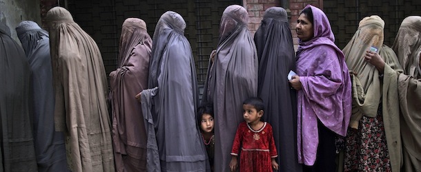 Pakistani women line up to enter a polling station and cast their ballots, on the outskirts of Islamabad, Pakistan, Saturday, May 11, 2013. Pakistanis streamed to the polls Saturday to vote in a historic election pitting a cricket star-turned-politician against an unpopular incumbent and a two-time prime minister, but twin bombings killing nine people and wounding dozens underlined the dangers voters face. (AP Photo/Muhammed Muheisen)