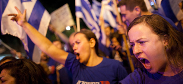 TEL AVIV, ISRAEL - MAY 11: (ISRAEL OUT) Demonstrators march through the streets to protest against Israeli Finance Minister Yair Lapid's budget cuts on May 11, 2013 in Tel Aviv, Israel. Thousands of Israelis took to the streets to protest against austerity measures presented this week as part of the state's new budget. (Photo by Uriel Sinai/Getty Images)