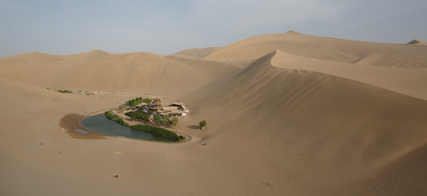 A photo taken on May 12, 2013 shows a general view of the Yueyaquan Crescent Lake in Dunhuang, in China's northwestern Gansu province. Formerly a silk route hub and centre for trade between China and the West, Dunhuang relies heavily on tourism and features a number of historic sites dating back to the Han Dynasty. The city has an arid climate and is surrounded by sand dunes, a result of increasing desertification. AFP PHOTO / Ed Jones (Photo credit should read Ed Jones/AFP/Getty Images)