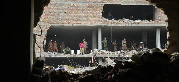 Rescue work in progress at the site of a garment factory building that collapsed in Savar near Dhaka, Bangladesh, Wednesday May 8, 2013. Dozens of bodies recovered Wednesday from the building were so decomposed they were being sent to a lab for DNA identification, police said, as the death toll from Bangladesh's worst industrial disaster topped 800. (AP Photo/Ismail Ferdous)