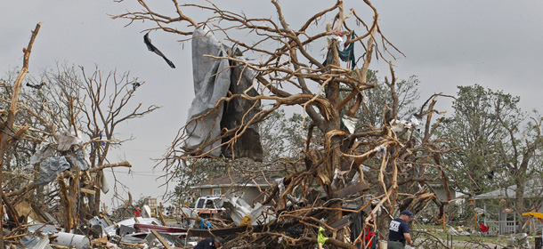 Crushed autos sit amid the rubble of destroyed homes as emergency personnel continue search efforts to locate unaccounted for people in the Rancho Brazos neighborhood in Granbury, Texas, Thursday, May 16, 2013. A rash of tornadoes slammed into several small communities in North Texas overnight, leaving at least six people dead, dozens more injured and hundreds homeless. (AP Photo/The Fort Worth Star-Telegram, Paul Moseley) MAGS OUT; (FORT WORTH WEEKLY, 360 WEST)