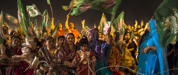 LAHORE, PAKISTAN - MAY 09: Supporters wait for the arrival of Nawaz Sharif leader of the Pakistan Muslim League-N (PML) party during the final day of campaigning at an election rally on May 09, 2013 in Lahore, Pakistan. Imran Khan, chairman of Pakistan Tehrik e Insaf (PTI) was injured at a rally in Lahore on Tuesday after having fallen 15 feet whilst being lifted onto a stage with only 2 days of campaigning to go. Nawaz Sharif of the Pakistan Muslim League-N (PMLN) cancelled one day of campaigning in respect to his injured opponent yesterday. In the last day of campaigning Imran Khan addressed a rally via telecast from his bedside in hospital. Nawaz held his final rally in his stronghold city of Lahore. Pakistan's parliamentary elections are due to be held on May 11. It is the first time in the country's history that an elected government will hand over power to another elected government. (Photo by Daniel Berehulak/Getty Images)