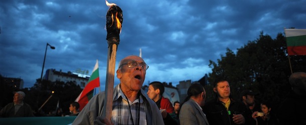 Protestors hold torches during a protest in front of the National Palace of Culture in Sofia on May 12, 2013. Bulgarian ousted premier Boyko Borisov's party came first in tense elections today but fell short of a majority, exit polls showed, setting the scene for political stalemate and fresh protests. Three months after the biggest demonstrations in years prompted the former bodyguard to tender his government's resignation, Borisov's GERB party won between 30.3 and 33 percent of the vote, the exit polls showed. AFP PHOTO / NIKOLAY DOYCHIONOV