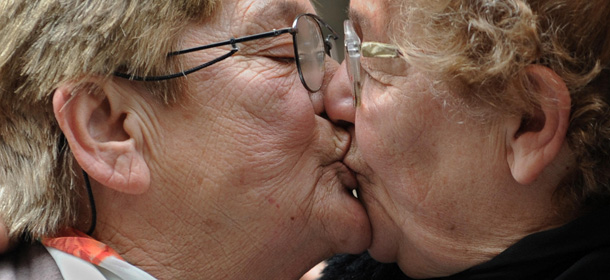 Norma Castillo (R), candidate for the pro-government Frente para la Victoria in the legislative elections, and Ramona Arevalo, both 67 years old, kiss each other as they exit the registry office after they legalized civil union in Buenos Aires and sealed a love that takes 30 years of shared living, amid a shower of rice and a release of balloons in support of equal rights for lesbian, gays and bisexuals, on June 19, 2009. AFP PHOTO / DANIEL GARCIA (Photo credit should read DANIEL GARCIA/AFP/Getty Images)