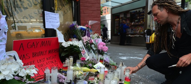 A man lights a candle at a makeshift shrine set on the location where Mark Carson, 32, a gay man, was shot dead in what police are calling a hate crime in Greenwich Village in New York, May 20, 2013. A suspect identified as Elliot Morales, 33, was arrested on a charge of second degree murder after he used homophobic slurs before firing a fatal shot point-blank into a Carson's face overnight May 17, 2013. AFP PHOTO/Emmanuel Dunand (Photo credit should read EMMANUEL DUNAND/AFP/Getty Images)
