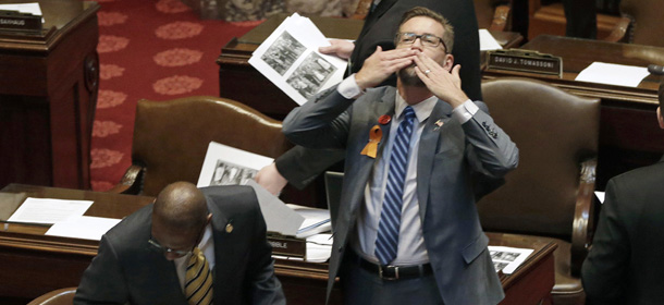 Sen. Scott Dibble, an openly gay lawmaker who sponsored the Senate's gay marriage bill, throws a kiss toward the gallery as the Senate prepared to debate the issue, Monday, May 13, 2013 in St. Paul, Minn. The bill passed the Minnesota House last week. (AP Photo/Jim Mone)