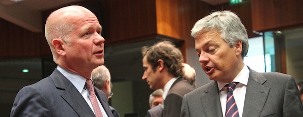 British Foreign Secretary William Hague, left, talks with Belgium's Foreign Minister Didier Reynders, during the EU foreign ministers meeting, at the European Council building in Brussels, Monday, May 27, 2013. The European Union nations remain divided on Monday whether to ease sanctions against Syria to allow for weapons shipments to rebels fighting the regime of Syria's President Bashar Assad. (AP Photo/Yves Logghe)