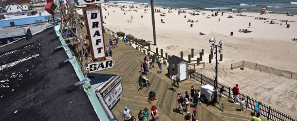 SEASIDE HEIGHTS, NJ - MAY 27: People walk on the boardwalk on the first weekend of Jersey Shore beaches re-opening to the public on May 27, 2013 in Seaside Heights, New Jersey. The region continues to recover and rebuild after Hurricane Sandy devastated parts of the coastline. (Photo by Kena Betancur/Getty Images)