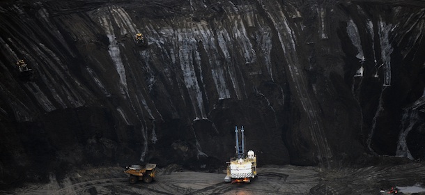 A large excavator loads a truck with oil sands at the Shell Albian mine near the town of Fort McMurray in Alberta on October 23, 2009. Greenpeace are calling for an end to oil sands mining in the region due to their greenhouse gas emissions and have recently staged sit-ins which briefly halted production at several mines. At an estimated 175 billion barrels, Alberta's oil sands are the second largest oil reserve in the world behind Saudi Arabia, but they were neglected for years, except by local companies, because of high extraction costs. Since 2000, skyrocketing crude oil prices and improved extraction methods have made exploitation more economical, and have lured several multinational oil companies to mine the sands. AFP PHOTO/Mark RALSTON (Photo credit should read MARK RALSTON/AFP/Getty Images)