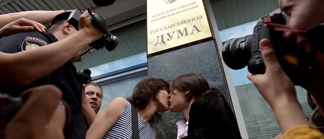 Russian gay rights activists kiss each other outside the lower house of Russias parliament, the State Duma, in Moscow, on June 11, 2013, during their protest action. Russia's parliament debated today a law introducing steep fines and jail terms for people who promote homosexual "propaganda" to minors, a measure critics fear will be used to justify the repression of gays amid rising homophobia in the country. AFP PHOTO / KIRILL KUDRYAVTSEV (Photo credit should read KIRILL KUDRYAVTSEV/AFP/Getty Images)