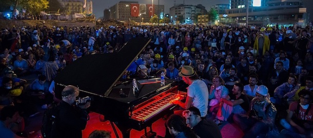 ISTANBUL, TURKEY - JUNE 12: A man plays piano while hundreds of other protesters listen at Taksim Square, on June 12, 2013 in Istanbul, Turkey. Istanbul has seen protests rage on for days, with two protesters and one police officer killed. What began as a protest over the fate of Taksim Gezi Park, has turned into a wider demonstration over Prime Minister Recep Tayyip Erdogan's policies. (Photo by Lam Yik Fei/Getty Images)