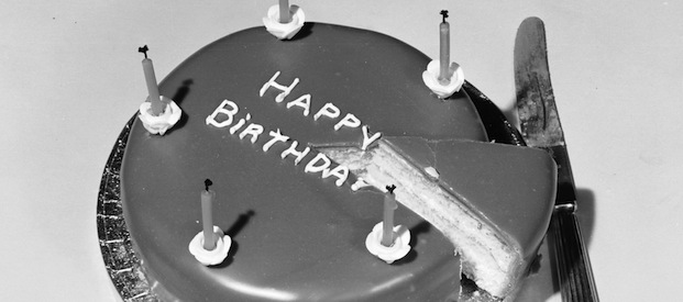 25th February 1955: A sponge birthday cake has chocolate icing and five candles. (Photo by Chaloner Woods/Getty Images)