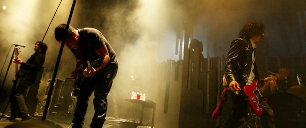 LOS ANGELES - DECEMBER 10: Bassist Jeordie White, Trent Renzor and guitarist Aaron North of Nine Inch Nails performs at 106.7 KROQ's "Almost Acoustic Christmas" at Gibson Ampitheater at Universal Studios on December 10, 2005 in Los Angeles, California. (Photo by Karl Walter/Getty Images)