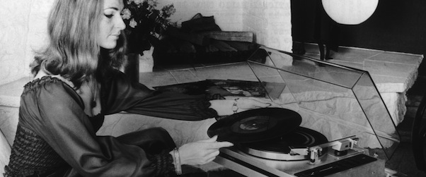 A woman using an automatic record player made by Philips, at the International Radio Show in Berlin, circa 1974. The turntable automatically places the pick-up on the record, lifts it off again when it reaches the end of the side and stops the motor. (Photo by Keystone/Hulton Archive/Getty Images)