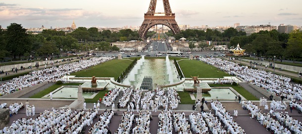 Participants dressed in white take part in a big open air white dinner at the Trocadero gardens, in front the Eiffel Tower, in Paris, Thursday, June 13, 2013. The event is a reminiscent of flash mobs, where hundreds of people descend on one area at a specific time, summoned by SMS text message, gsm phone call or email. (AP Photo/Thibault Camus)