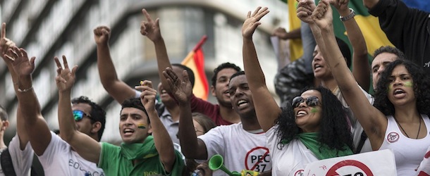 People shout anti-government slogans during a protest in Belo Horizonte, Brazil, Saturday, June 22, 2013. Demonstrators once again took to the streets of Brazil on Saturday, continuing a wave of protests that have shaken the nation and pushed the government to promise a crackdown on corruption and greater spending on social services. (AP Photo/Felipe Dana)