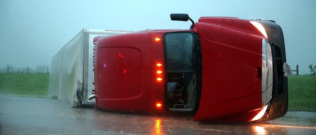 An overturned semitrailer rests on its side on the eastbound lanes of Interstate 40, just east of El Reno, Okla., after a reported tornado touched down, Friday, May 31, 2013. (AP Photo/The Omaha World-Herald, Chris Machian)