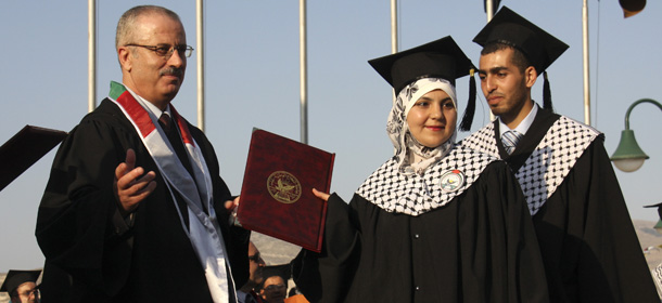 In this June 15, 2011 photo, Dr. Rami Hamdallah, left, a president of the al-Najah University attends the graduation ceremony in Nablus. The Palestinian president Mahmoud Abbas on Sunday June 2, 2013, picked a little-known academic, Dr. Rami Hamdallah, as his new prime minister, according to the official government news agency, following the resignation of his chief rival. (AP Photo/Nasser Ishtayeh)