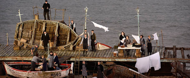 ALDEBURGH, ENGLAND - JUNE 17: Cast members take to the stage during the first performance of 'Grimes on the Beach', a production of Benjamin Britten's opera Peter Grimes at the Aldeburgh festival on June 17, 2013 in Aldeburgh, England. Tim Albery directs an outdoor realisation of 'Peter Grimes' that places the audience directly in its setting on the beach. (Photo by Bethany Clarke/Getty Images)
