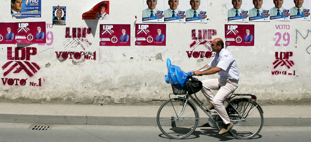 A man rides a bicycle next to electoral posters in downtown Tirana on June 22, 2013. Albanians will go to the polls on June 23 to elect the 140 members of the Albanian Parliament. AFP PHOTO / GENT SHKULLAKU (Photo credit should read GENT SHKULLAKU/AFP/Getty Images)