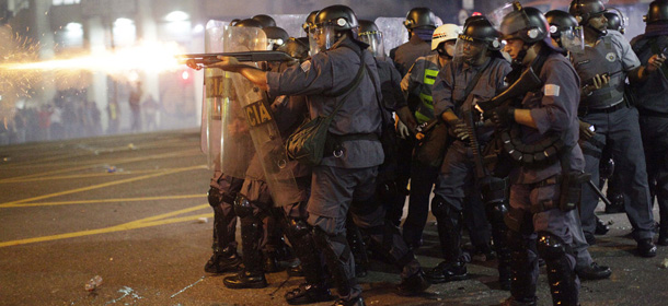 Police fire rubber bullets at people protesting the increase in the price of public transportation in Sao Paulo, Brazil, Thursday, June 13, 2013. The price to ride the bus and subway rose from 3 Reales to 3.20 Reales, which is about 1.50 U.S. dollars. (AP Photo/Nelson Antoine)