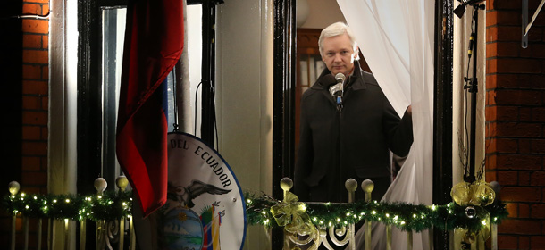 LONDON, ENGLAND - DECEMBER 20: Wikileaks founder Julian Assange parts the curtains as he starts to speak from a balcony at the Ecuadorian Embassy on December 20, 2012 in London, England. Mr Assange has been living in the embassy since June 2012 in an attempt to avoid extradition to Sweden where he faces allegations of sexual assault. (Photo by Peter Macdiarmid/Getty Images)