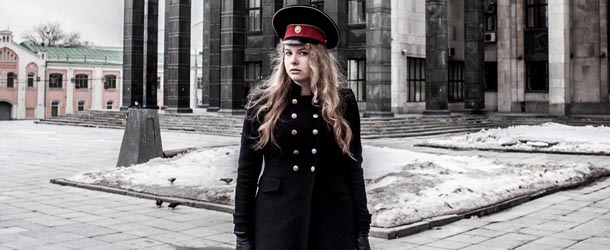 Moscow, 1th apr 2013 . A girl with army red hat in front of the Russian State Library is the national library of Russia. It is the largest in the country and the third largest in the world for its collection of books (17.5 million).