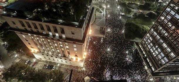 Students take part in a demonstration next to the city hall building and the Municipal Theater in Sao Paulo, Brazil on June 18, 2013, against a recent rise in public bus and subway fare from 3 to 3.20 reais (1.50 USD). President Dilma Rousseff vowed Tuesday to listen to youths staging Brazil's biggest protests in 20 years in an outpouring of anger over the huge cost of staging events like the World Cup. AFP PHOTO/Miguel SCHINCARIOL (Photo credit should read Miguel Schincariol/AFP/Getty Images)