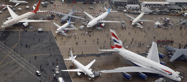 An aerial view of a British Airways Airbus A380, bottom right, and an Air India Boeing 787 Dreamliner left, parked on the tarmac of the 50th Paris Air Show at Le Bourget airport, north of Paris, Wednesday, June 19, 2013. (AP Photo/Francois Mori)