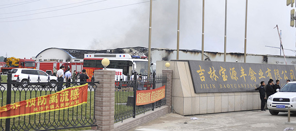 In this photo released by China's Xinhua News Agency, smoke rises from a poultry farm at the Jilin Baoyuanfeng Poultry Company in Mishazi township of Dehui City, northeast China's Jilin Province Monday, June 3, 2013. At least 43 people were killed on Monday morning in the poultry processing plant fire. Reports say 43 people have died in the fire which broke out Monday morning. (AP Photo/Xinhua, Wang Haofei) NO SALES