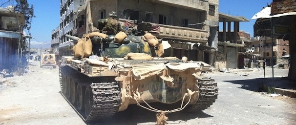 A tank of the Syrian army drives in a street left in ruins on June 5, 2013 in the city of Qusayr in Syria's central Homs province, after the Syrian government forces seized total control of the city and the surrounding region. The Syrian army ousted rebels from the strategic town of Qusayr after a blistering 17-day assault led by Hezbollah fighters, scoring a major battlefield success in a war that has killed at least 94,000 people. AFP PHOTO / STR (Photo credit should read -/AFP/Getty Images)